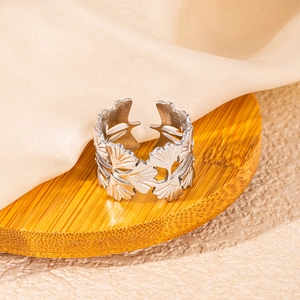 Detailed close-up of silver ginkgo leaf open ring with intricate hollowed patterns