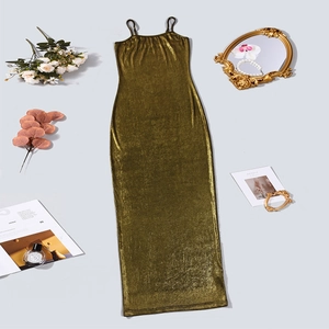 Flat lay of a backless gold slip dress with metallic sheen and luxury fashion accessories