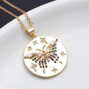 Close-up of gold butterfly pendant featuring colorful zircons and star details
