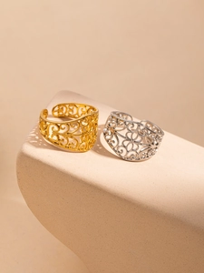 Detail of vintage hollow-out 18K gold and silver plated stainless steel open rings set