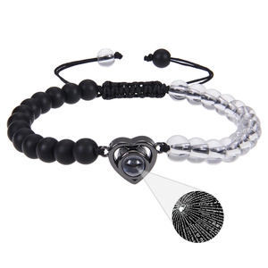 Detail of heart projection stone showing I Love You in 100 languages on beaded bracelet