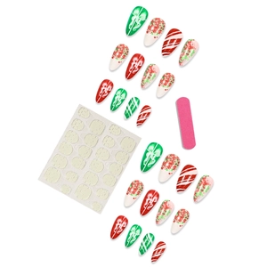 Christmas press-on nail kit with red, green, and white snowflake patterns and tools