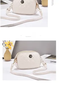 Detail of cream quilted crossbody bag with black camellia floral buckle and gold zipper
