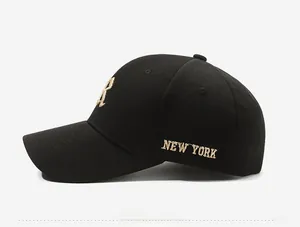 Detail of gold New York embroidery and fabric texture on a black baseball cap