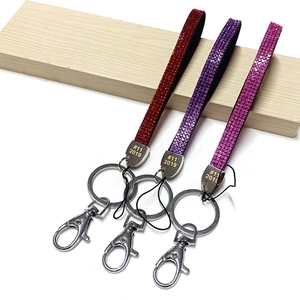 Sparkling crystal rhinestone wrist straps in red, purple, and rose colors with metal rings