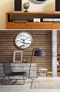 Detail of silver metal wall clock with minimalist low poly dial and Arabic numerals