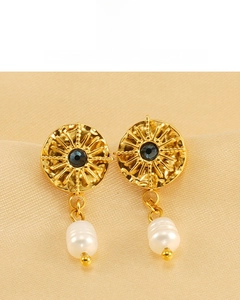 Detail of 18K gold plated vintage sunburst earrings with black stone and baroque pearls