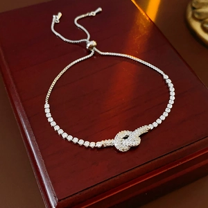 Macro view of adjustable knot bracelet with zirconia inlay on premium jewelry box