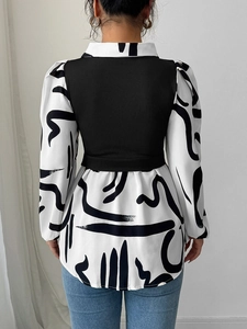 Women's black and white printed shirt with bubble sleeves and ruffled hem back view