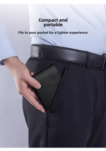 Close-up of slim black lychee pattern leather wallet being placed into a trouser pocket