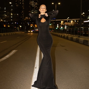 Detail of elegant black bodycon dress featuring a teardrop cutout and shimmering fabric