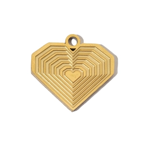 Detail view of heart-shaped gold pendant with concentric texture on a white background