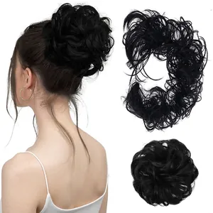 Detail view of black messy hair bun scrunchie on a model with close-up texture