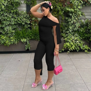 Detail view of black off-shoulder slim fit jumpsuit with elegant draped sleeves and capri length