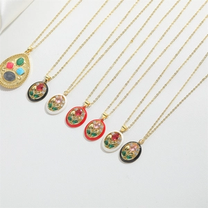 Flat lay of vintage gold-plated necklaces with colorful zircon flower pendants