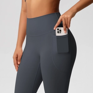 Close-up of high-waisted yoga pants featuring a practical side pocket for phone storage