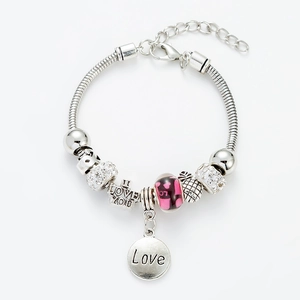 Detail of silver snake chain bracelet with pink heart beads and love charms