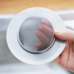 Stainless steel kitchen sink strainer with fine mesh and wide rim for drain protection