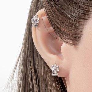 Rotating Ferris wheel cartilage piercing stud and ear cuff with silver zircons on model