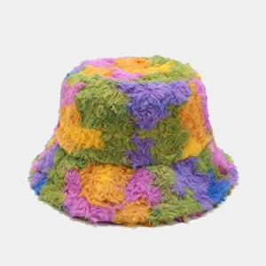 Detailed texture of multi-color plush bucket hat with vibrant faux fur patchwork
