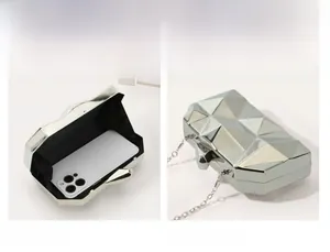 Macro view of silver geometric clutch with chain strap and interior smartphone size comparison