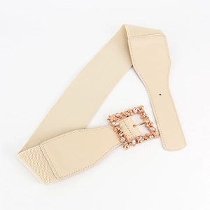 Detail of beige elastic belt with rose gold square buckle and shimmering rhinestones