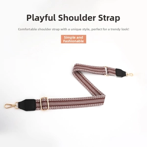 Detail of adjustable 38mm striped fabric bag strap with golden metal hardware