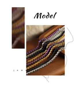 Detail of oval leaf chain links in multi-color finishes on a wooden tray display