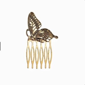 Detailed close-up of a vintage bronze butterfly hair comb with a six-tooth metal design