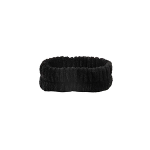 Macro detail of black coral fleece headband with thick elastic ribbed texture for skincare