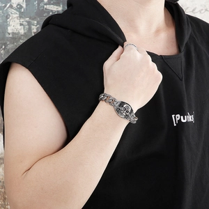 Detail of vintage silver skull bracelet for men with retro punk style metal texture