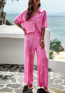 Detail of pink two-piece set with white abstract prints and short sleeves for summer