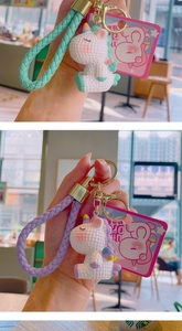 Detail of cute unicorn keychains in mint green and purple with woven wristlet straps