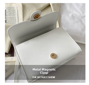 Detailed close-up showing the gold magnetic buckle closure of the white PU crossbody bag