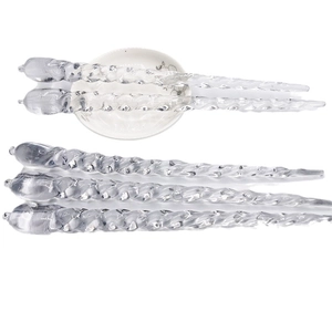 Set of five transparent spiral icicle ornaments for Christmas tree decoration on white surface