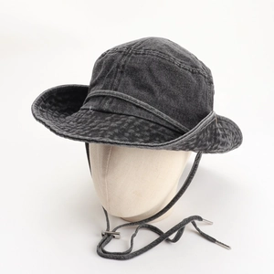 Detail of dark grey washed denim bucket hat with wide brim and adjustable chin strap