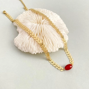 Vintage gold leaf chain necklace featuring a polished red agate stone on white coral