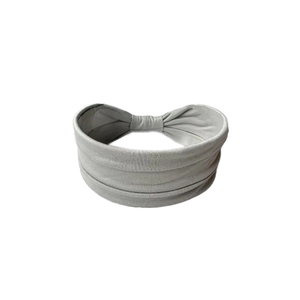 Detail view of the soft grey elastic fabric headband with wide-width design for women
