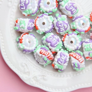 Macro shot of colorful DIY resin beads with Lucky and Happy text for handmade crafts
