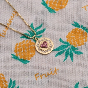 Gold plated necklace with red heart pendant and radiant sunburst diamond border