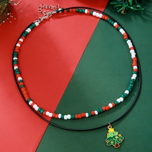 Detail of double-layer Christmas necklace with seed beads and festive tree pendant