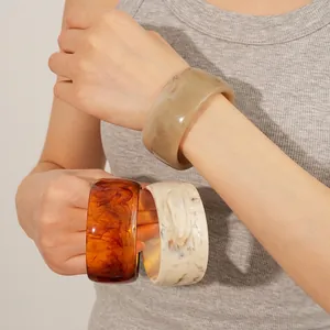 Retro resin bangle set in marble and tortoiseshell patterns worn on a wrist
