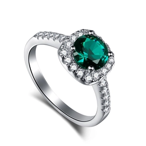 Classic silver ring with a halo-set green zircon and shimmering micro-pave white stones
