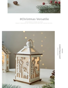 Close-up of wooden Christmas lantern with reindeer and snowflake cutout designs