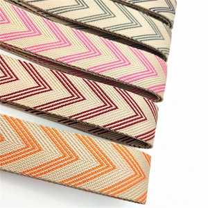 Close-up of four woven bag straps with colorful V-shape patterns on a white background