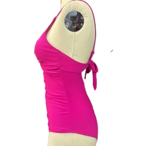 Detail view of fuchsia one-piece swimsuit featuring side ruching and adjustable back ties