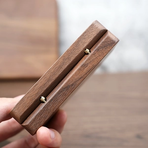 Detailed macro shot of premium walnut jewelry box with high-quality golden metal hinges