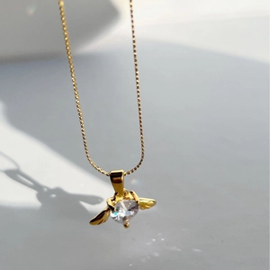 Golden heart necklace with sparkling zircon and angel wing pendant on thin chain