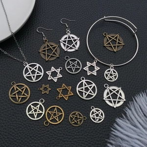 Flat lay of vintage silver and bronze star pendants for DIY jewelry and necklaces