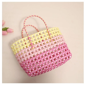 Top view of colorful woven tote bag with vibrant gradient pink and yellow hollow design